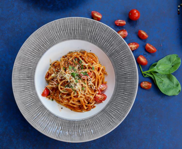 a plate with pasta on a blue background