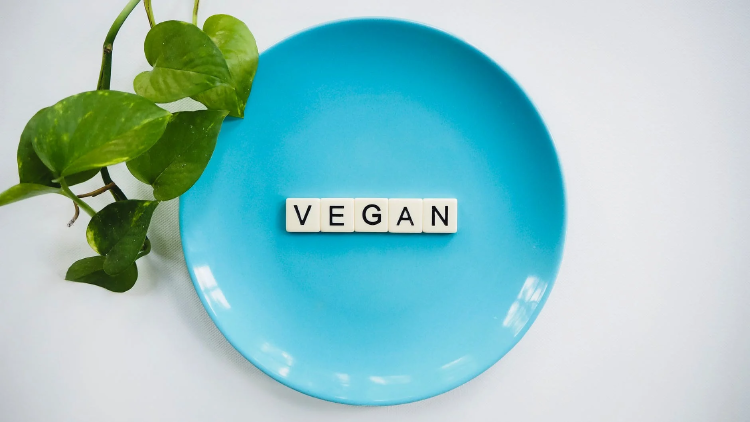 vegan scrabble tiles speling vegan in blue ceramic plate