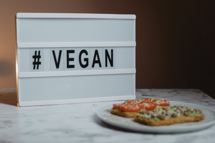 vegan post white and black sign reading vegan