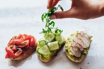 three slices of bread with fresh vegetables on top