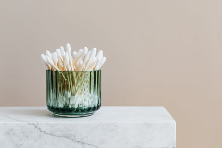 cotton buds photo of white cotton buds with non-plastick stick in a green vase