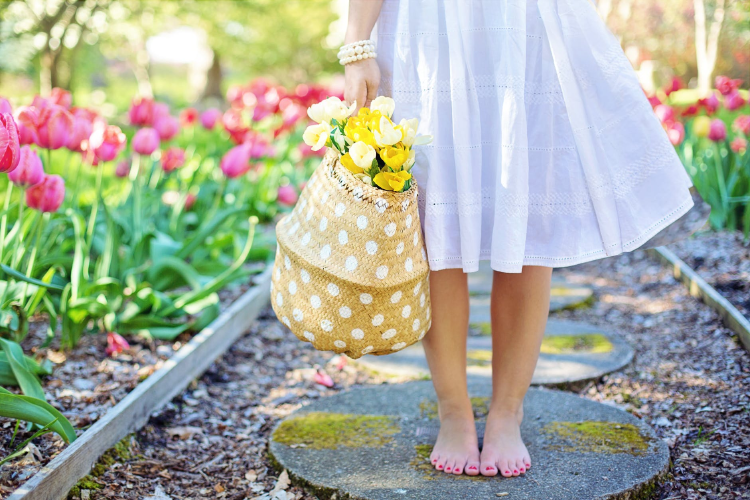 girl wearing a white cotton dress in a garden