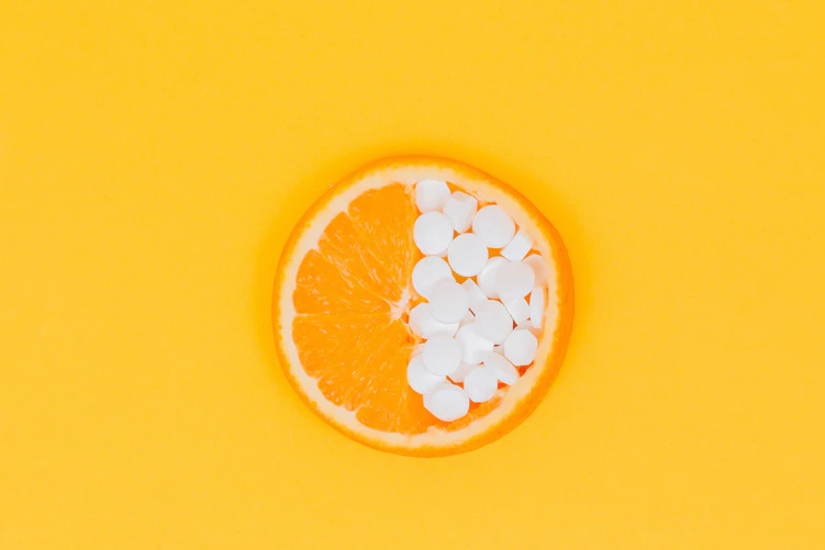 vitamins on a yellow, orange background