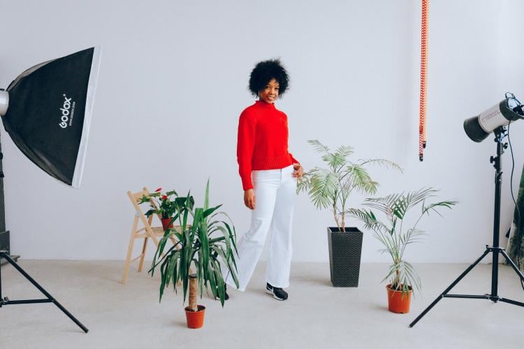 a woman being photographed with plants a woman being photographed with plants