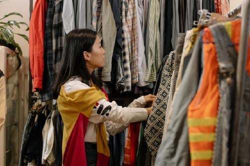Woman shopping secondhand clothes Woman shopping secondhand clothes
