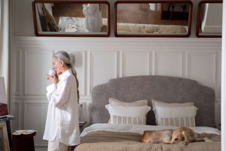 elderly woman drinking coffee in her bedroom