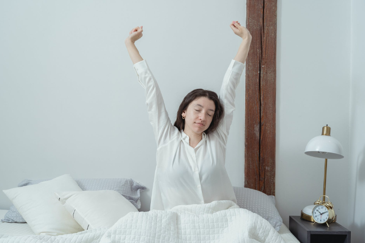 sleepy woman waking up in white pyjamas
