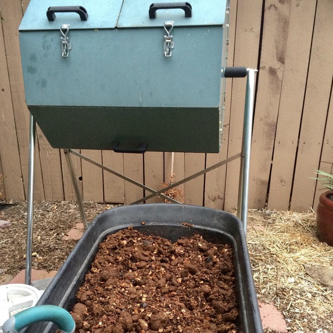 Mature compost in front of the Jora Composter