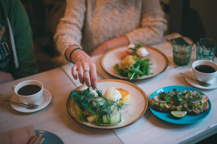 woman having meal with healthy food and strong coffee