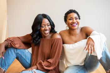 Two black women laughing next to each other
