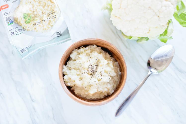 a cauliflower rice dish a cauliflower and some vegan cheese