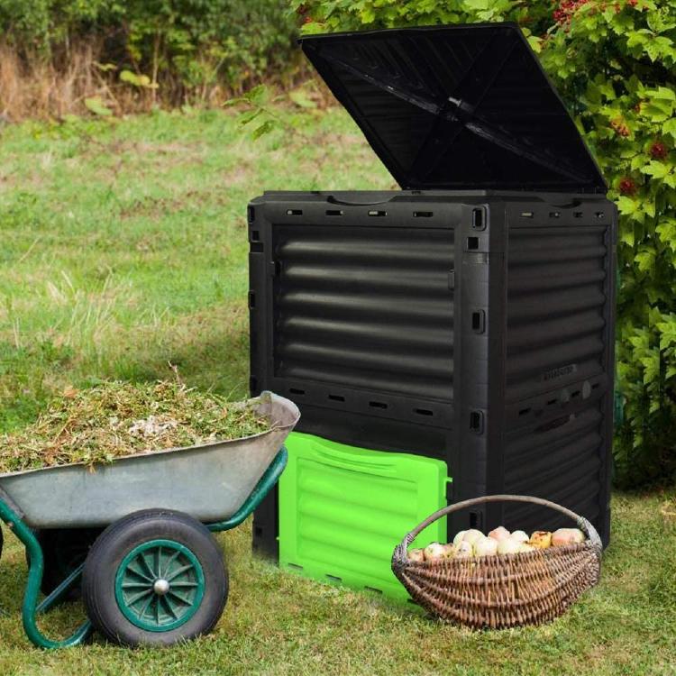 EJWOX The EJWOX composter next to basket with food waste and next to a wheelbarrow.