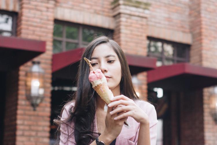 a girl holding an icecream cone