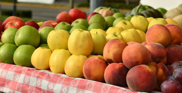 red and green apples, plump and peaches on market